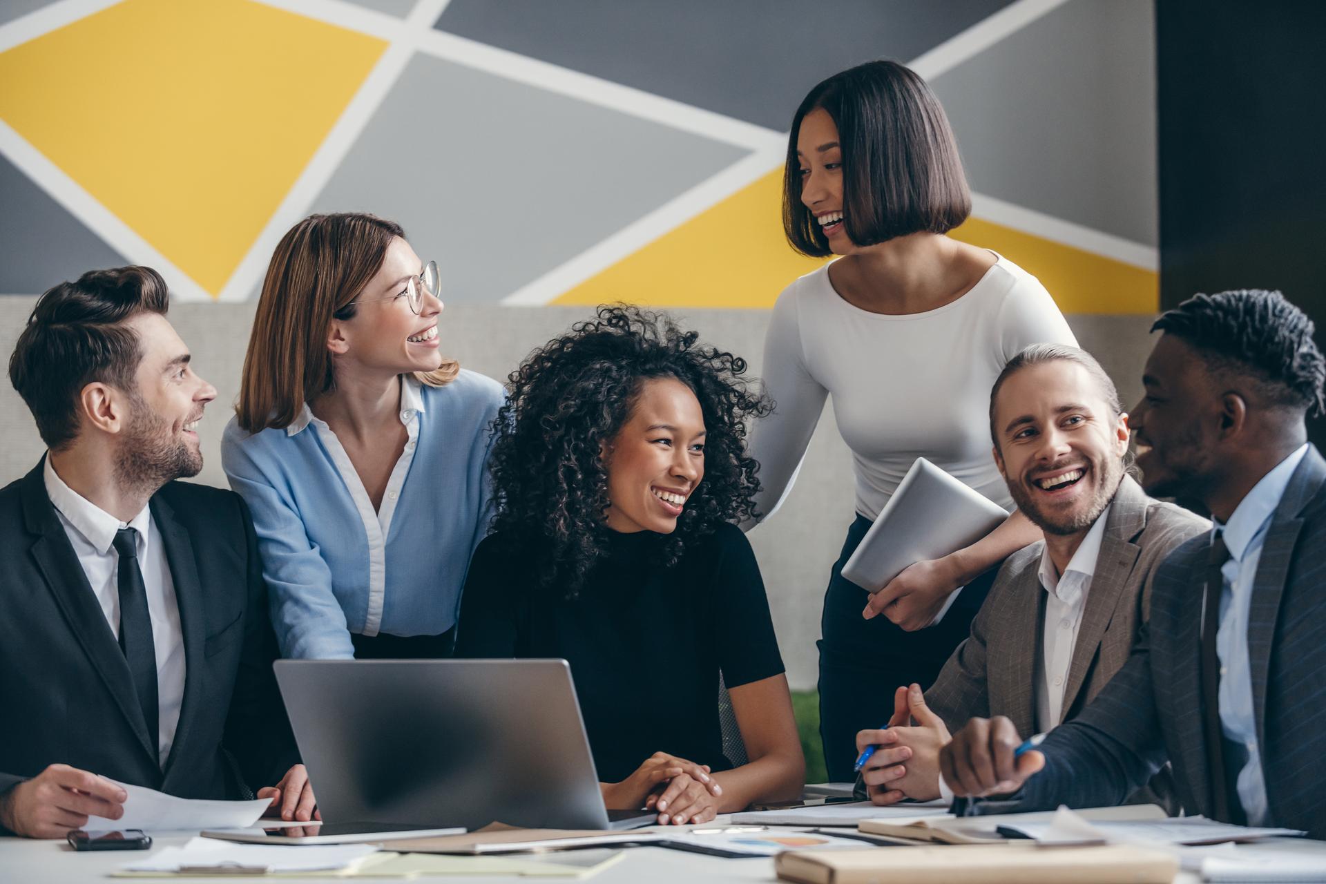 Happy young business team planning strategy while working at the modern office together